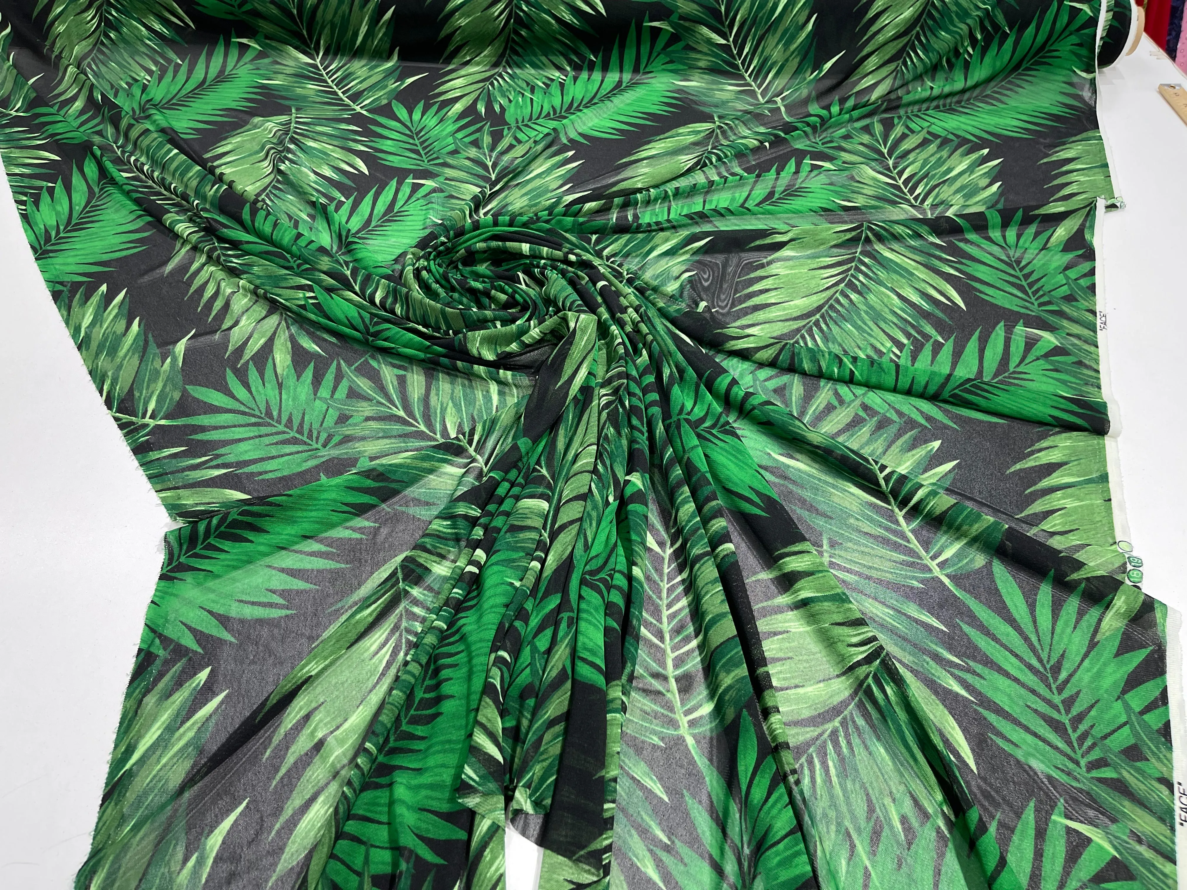 Green leaf design on a Black power mesh 4-way stretch 58"-Sold by the yard.