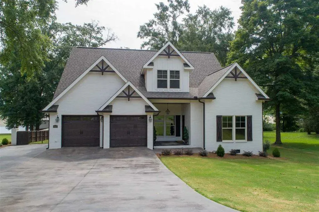 Spacious Family Home with Inviting Porches and Ample Garage Space